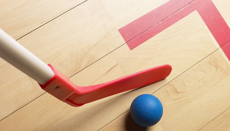 Field hockey stick and ball in gym