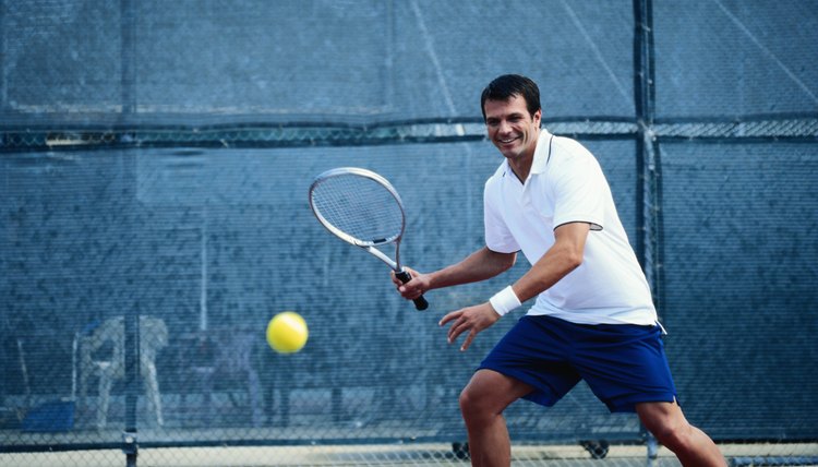 Young tennis player playing tennis, smiling