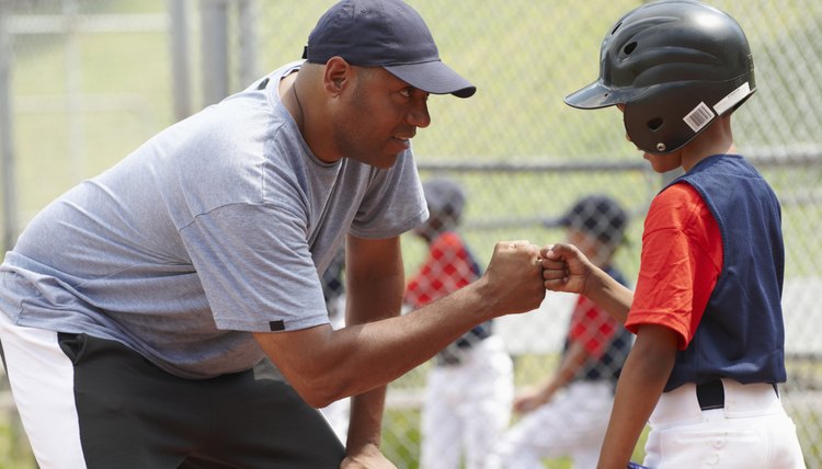 Coach Bumping Fists With Little League Batter