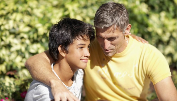 Dad talking and hugging son