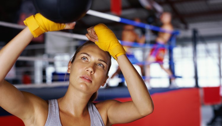 Close-up of a lady boxer hitting a speed bag