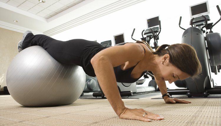 Woman doing pushups on exercise ball