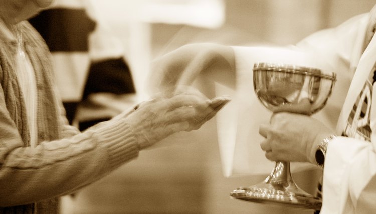 Priest handing out a communion wafer