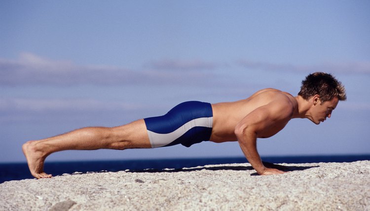 Man doing push-ups on beach