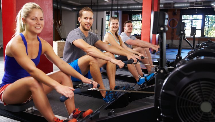Portrait Of Gym Class Working Out On Rowing Machines