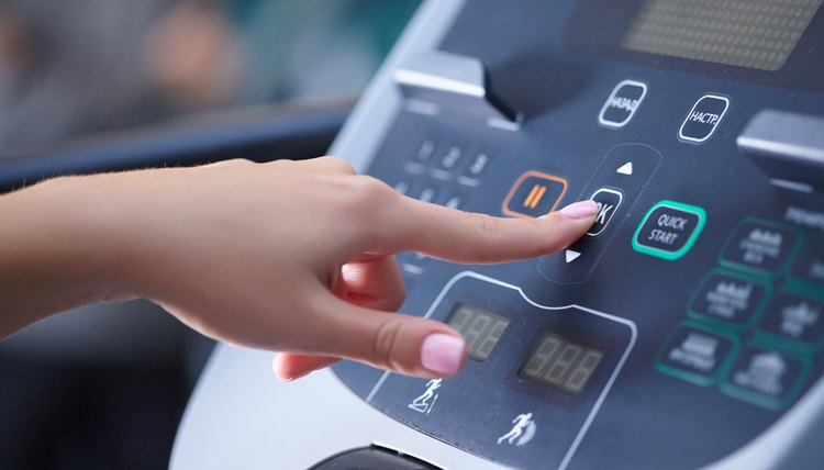 girl on a treadmill presses the button