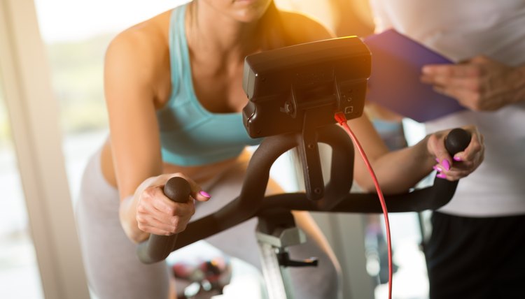 Woman on exercise bike at gym
