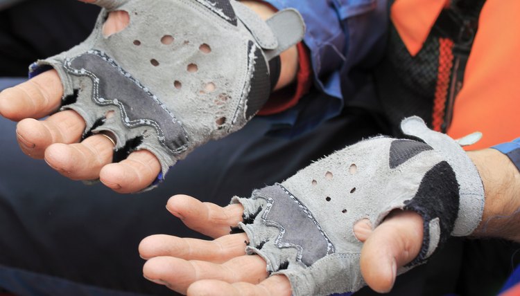 The hands of travelers in worn leather gloves