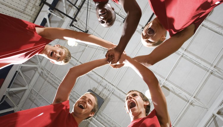 Basketball team in huddle yelling