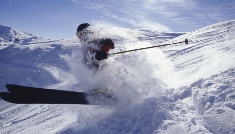 Skier landing in deep snow in mountains