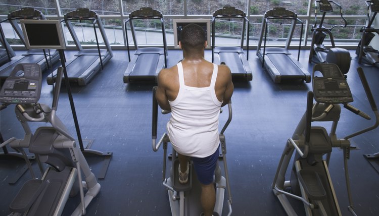 Man exercising on machine at gym