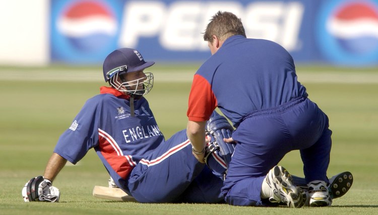 Michael Vaughan of England has his calf muscle treated
