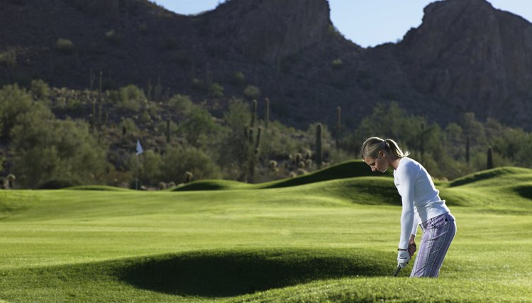 Woman playing golf on course