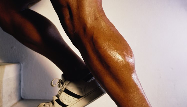 Close-up of the legs of a young man running up stairs