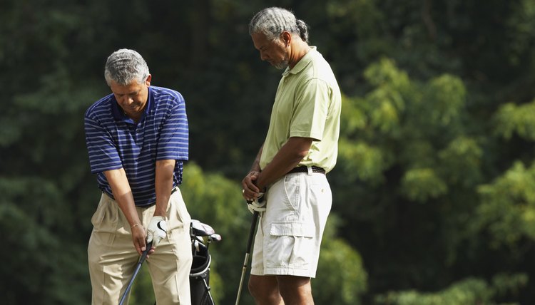 Multi-ethnic men playing golf