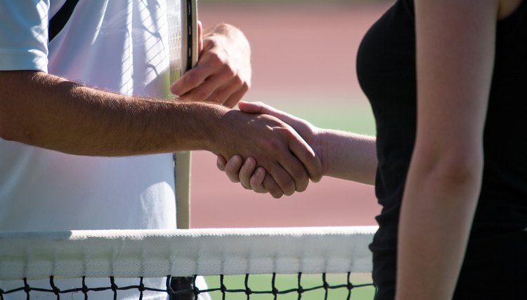 Tennis players shaking hands across net