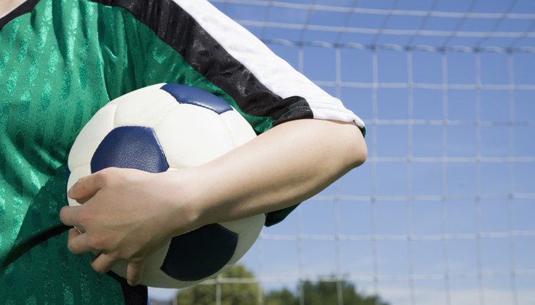 Soccer player's arm holding ball