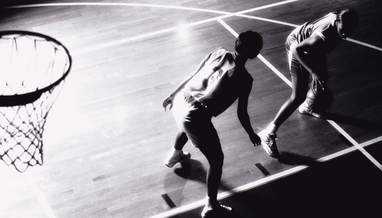 High angle view of two young women playing basketball