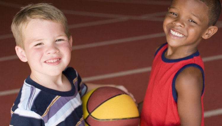 Boys with basketball in gym