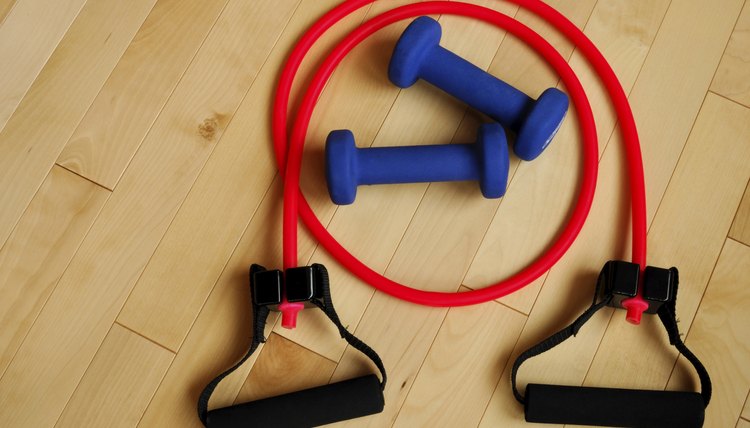 Red Resistance Band and Blue Weights on Gym Floor