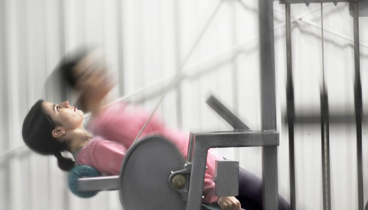 Woman Working Out On Exercise Machine