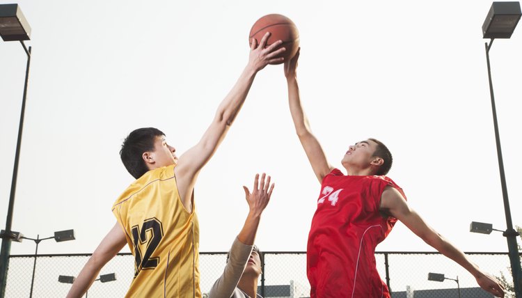 Basketball players fighting for a ball