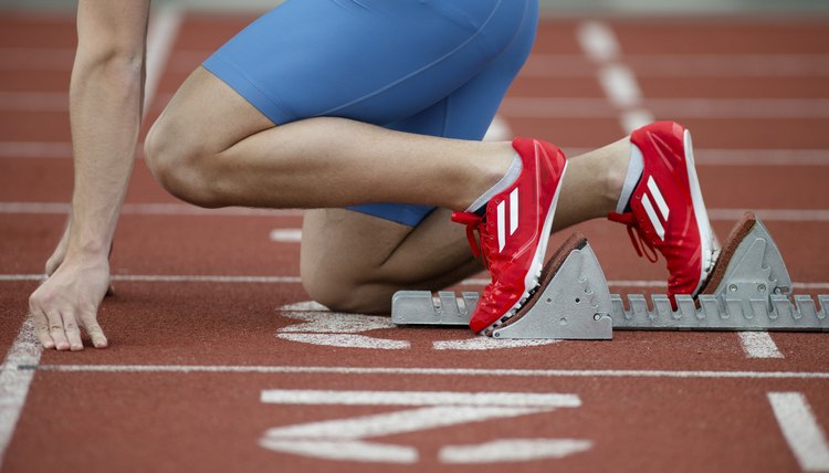 Detailed view of a sprinter in the starting blocks