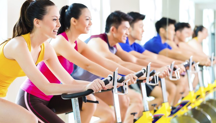 Asian people spinning bike training at fitness gym