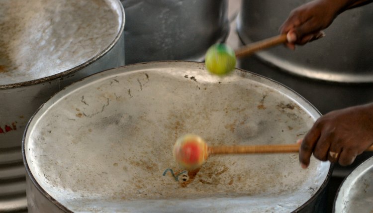 Musician's hands playing the steel drums.