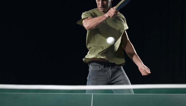 Young man playing table tennis (blurred motion)