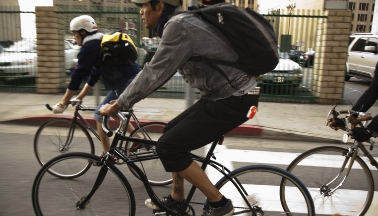 Men riding bicycles on city street