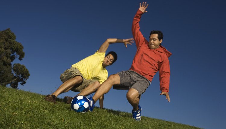 Two men playing soccer