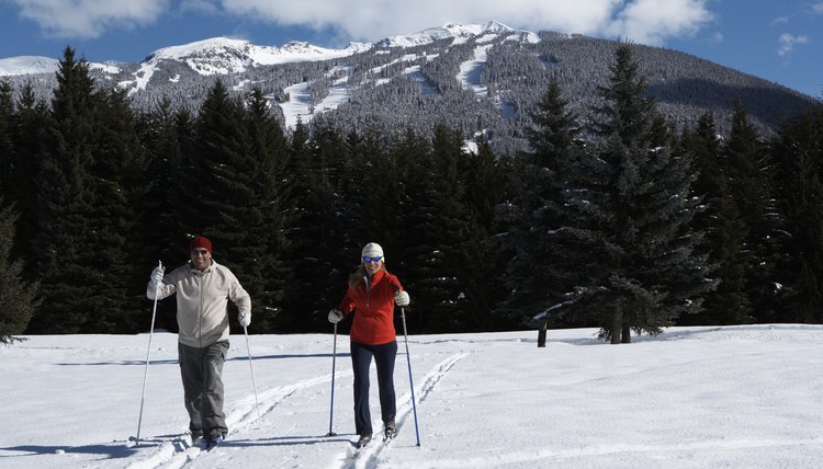 Mature man and woman cross-country skiing