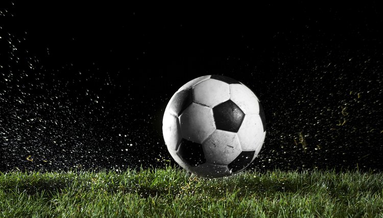 Soccer ball in motion over grass