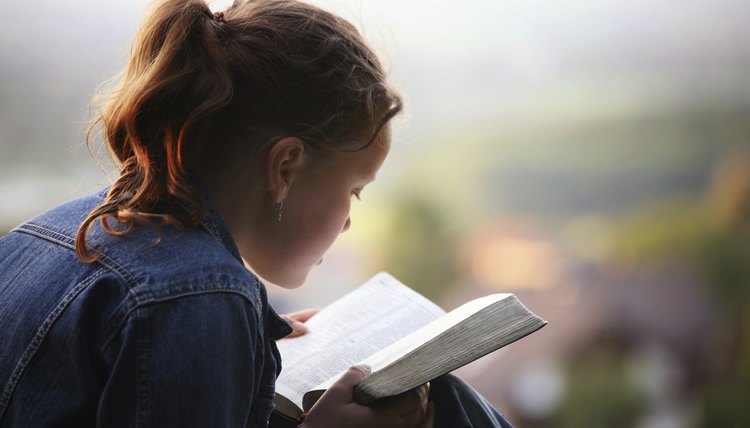 Reading a Bible outdoors.