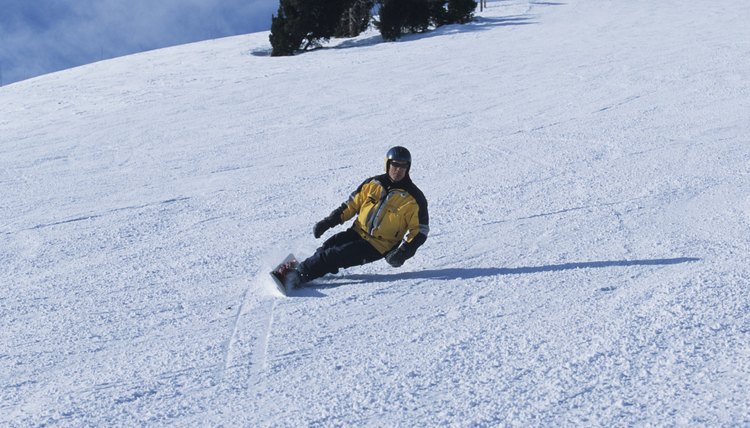 Snowboarder riding down slopes