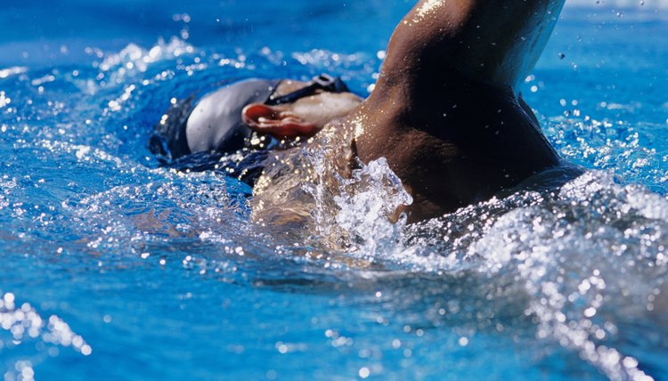 Young man swimming in  pool, close-up,