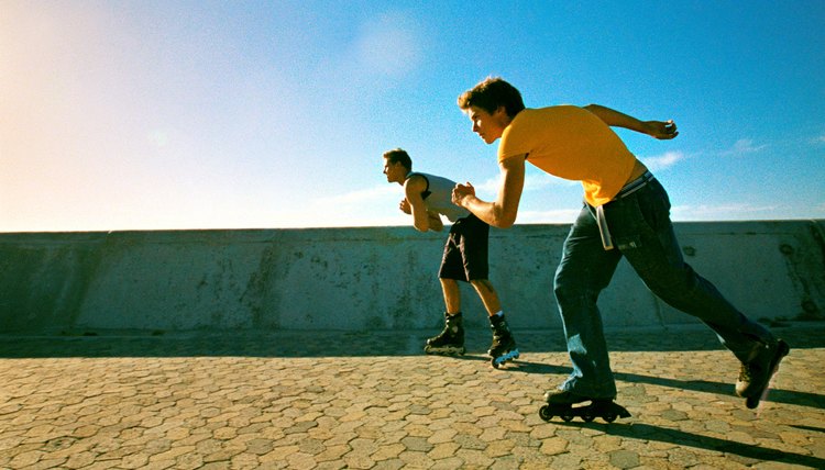 Two young men skating with in-line skates