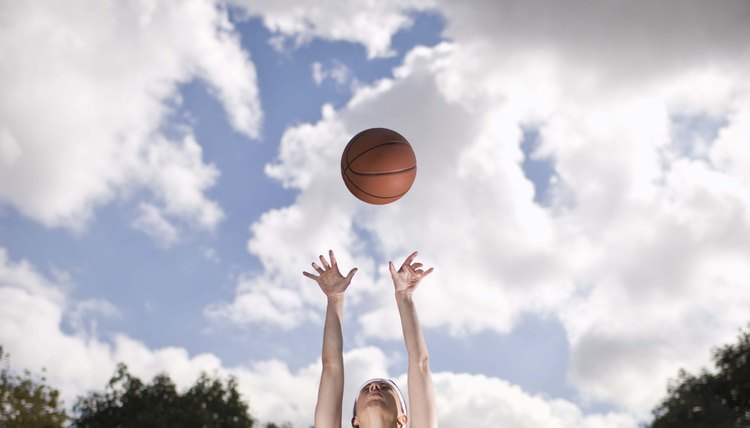 Woman playing basketball outdoors