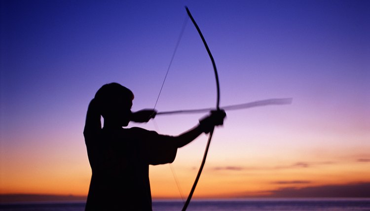 Boy shooting bow and arrow