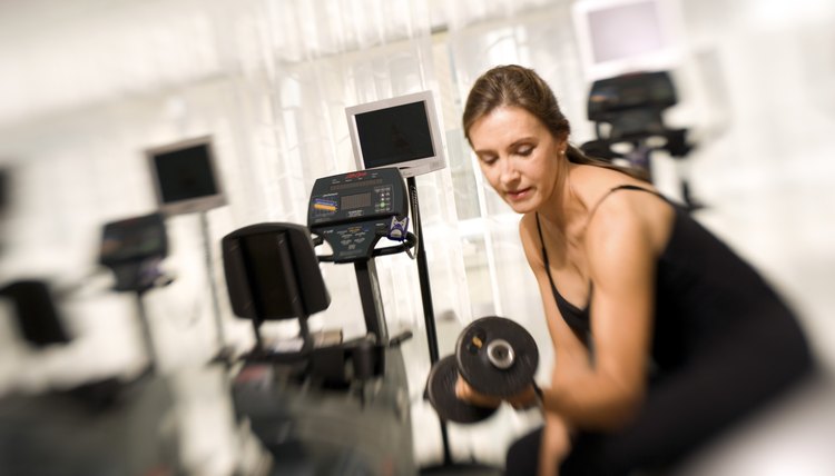 Woman lifting weights in gym