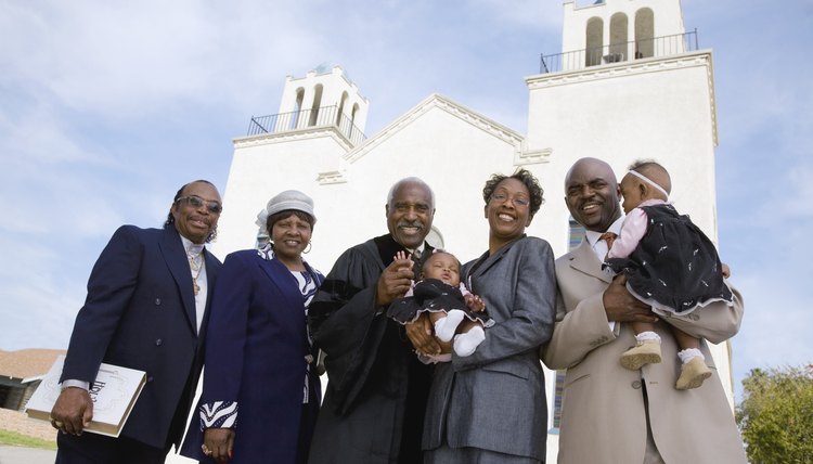A preacher and some of his congregation standing outside of a church.