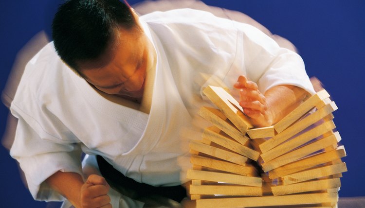 Man breaking boards with karate chop