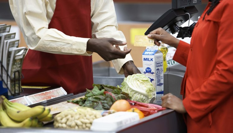 Shopper paying with credit card in market