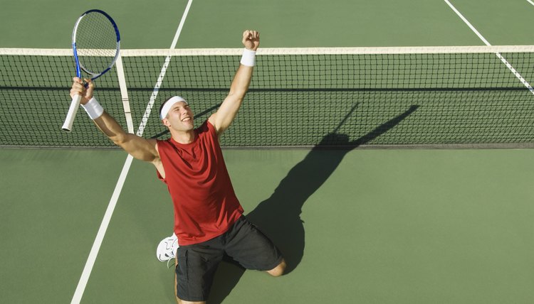 Victorious tennis player with arms outstretched