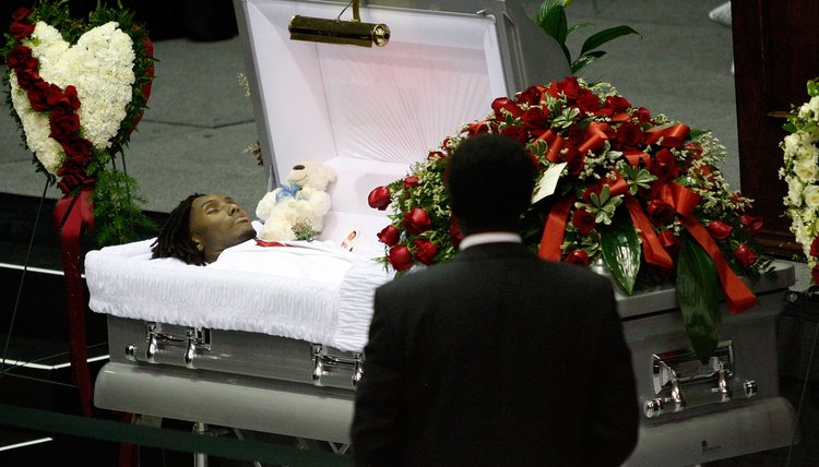 Embalming prepares a body for viewing and burial by delaying decomposition.