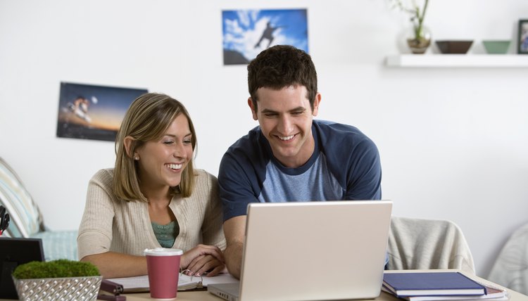 Two students are hanging out in a dorm room.