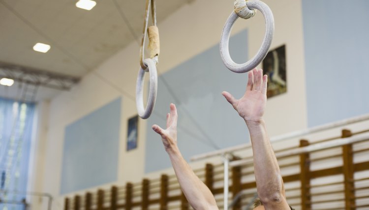 Male gymnast reaching for rings