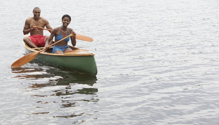 African couple paddling canoe