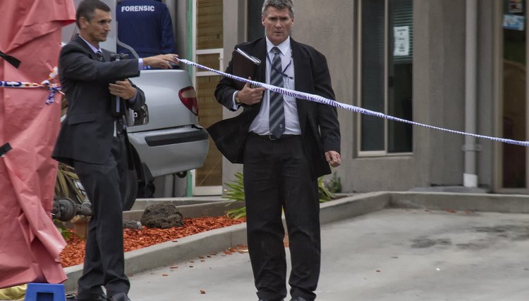 Homicide officer walking towards a crime scene.